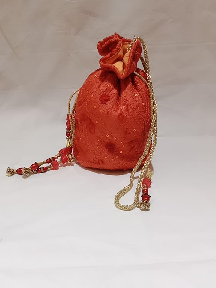 Nice Orange Colour Fancy Silk Potlis With Hand chikankari Lucknow chikan Emporium.