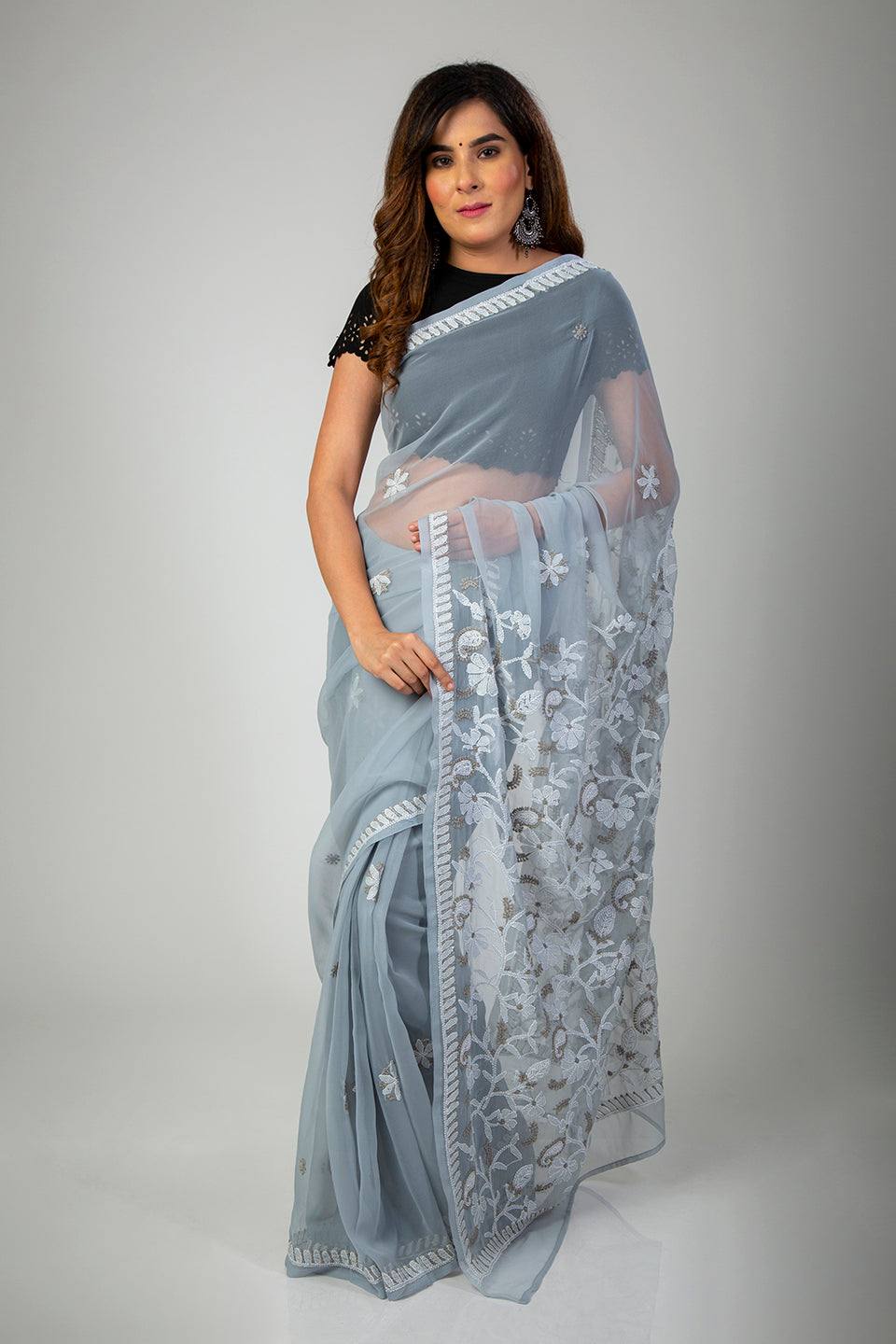 Lucknow Chikan Emporium Semi Georgette Mukesh work grey saree with blouse piece included.