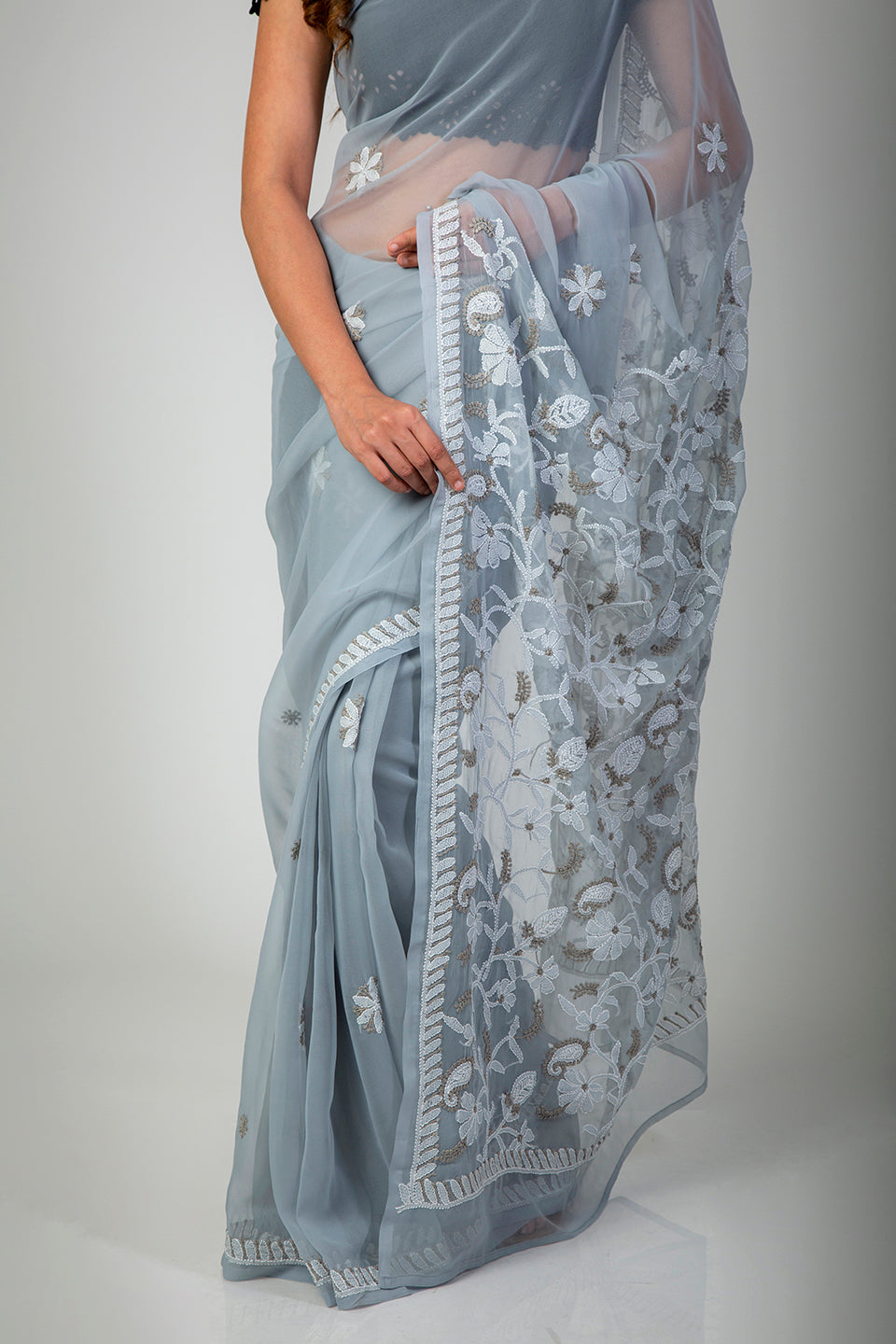 Lucknow Chikan Emporium Semi Georgette Mukesh work grey saree with blouse piece included.